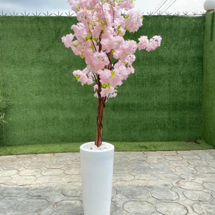 An artificial cherry blossom tree potted in a cone-shaped fiberglass vase is a breathtaking blend of elegance and modern style